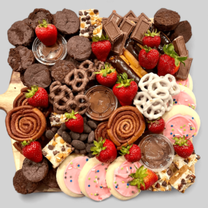 Sweet Treats board with an assortment of cookies, pretzels, strawberries, and mini brownies
