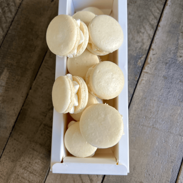 Vanilla macarons on top of box