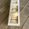 Vanilla macarons in a box with one on top