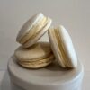 Vanilla macarons stacked on a pedestal